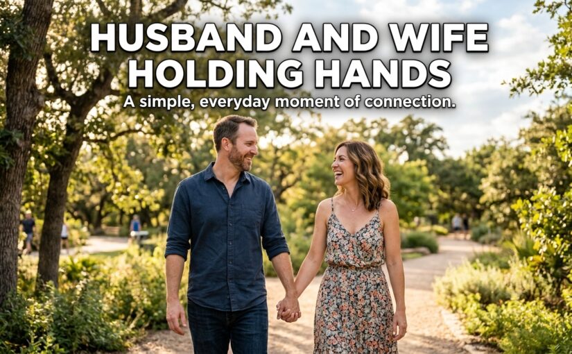 Husband and wife holding hands and smiling at each other outdoors